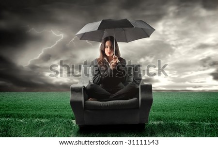 business woman on an armchair lost in countryside during a storm