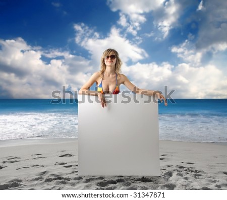 stock photo beach girl holding an empty sheet on the beach