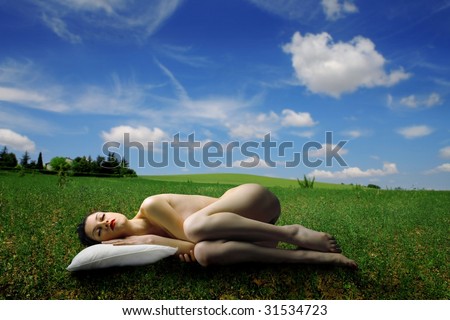 stock photo naked woman sleeping in a grass field stock photo naked woman sleeping in a grass field
