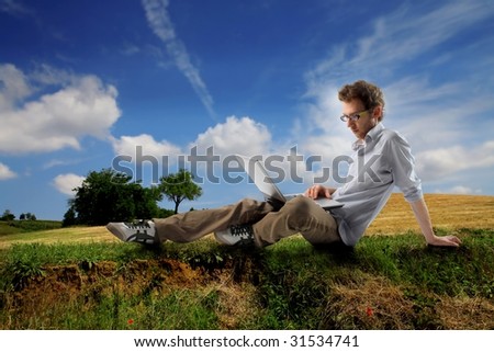 young man sitting in countryside