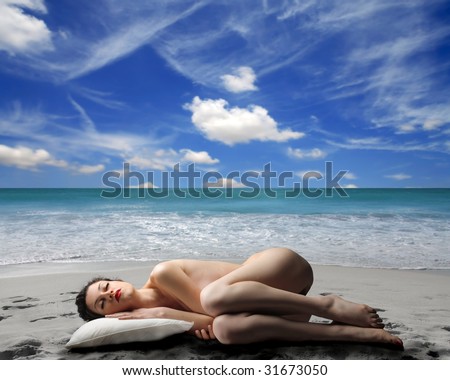 stock photo naked woman sleeping on the beach