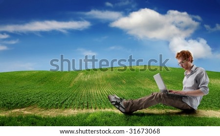student using laptop in the countryside