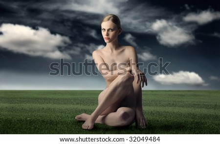 stock photo portrait of beautiful nude woman sitting on grass field