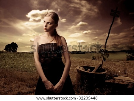 portrait of woman in black elegant dress in the country