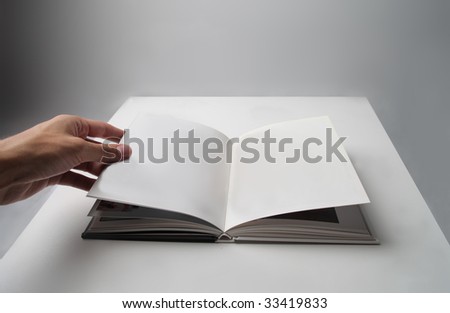 man\'s hand turning a page