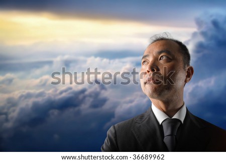 japanese businessman against a cloudy sky