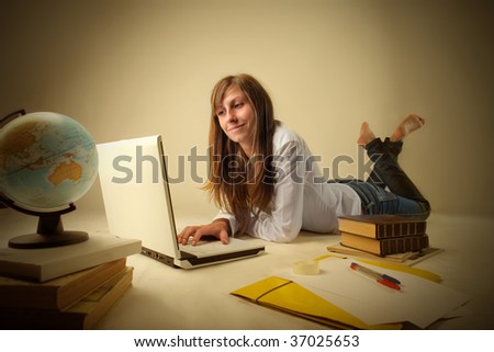 female teen studying with laptop and books