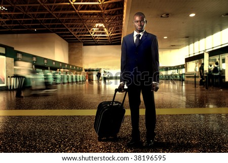 Black businessman with suitcase at the airport
