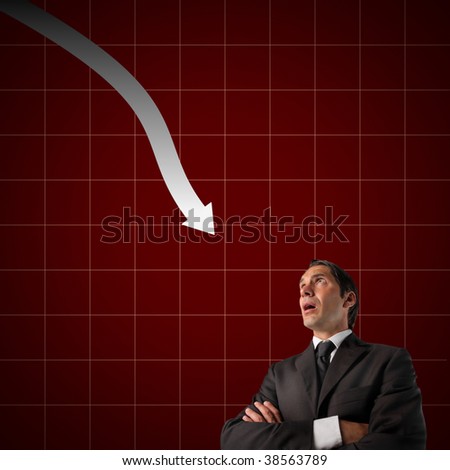businessman against financial graphic with descendant arrow