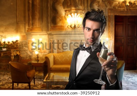 elegant guy holding a glass of wine in a luxury interior