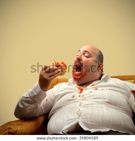 fat guy eating cheeseburger. portrait of fat man eating