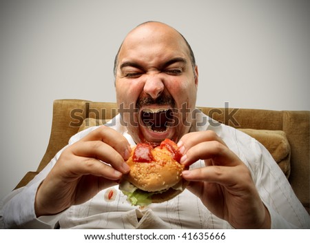 overweight man eating hamburger