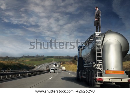 businessman standing on oil track