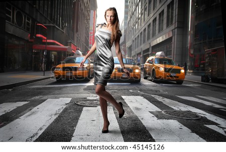 elegant model crossing a NY city street