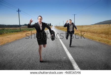 Portrait of a businessman and a businesswoman running on a countryside street