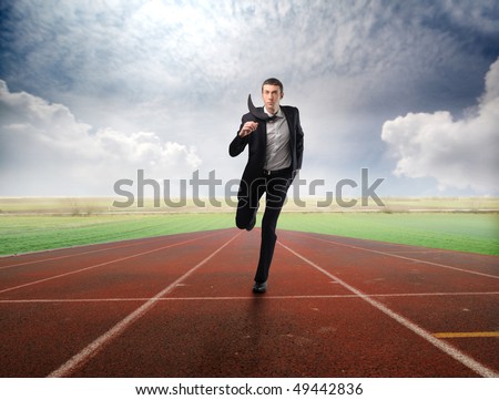 Businessman running on a racing track