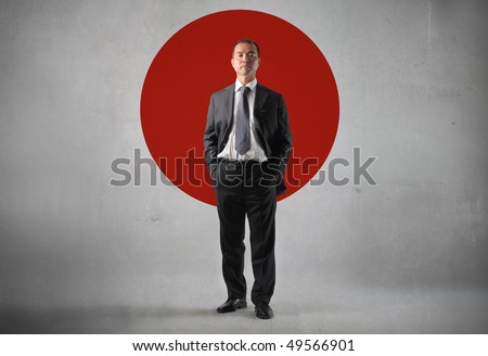 Japanese businessman standing in front of the japanese flag