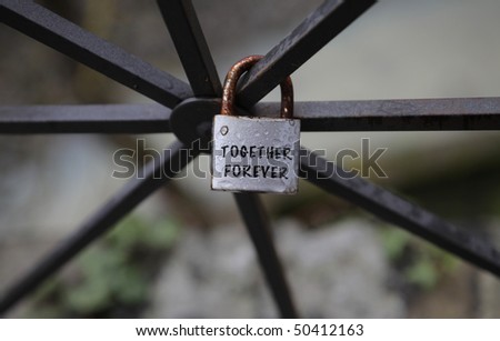 Closeup to a rusty padlock on a metal bar