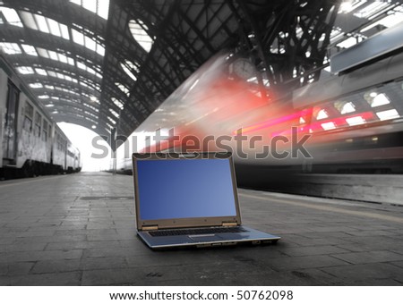 Laptop lying in the platform of a train station