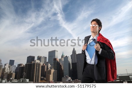 Businessman disguised in superman with cityscape on the background