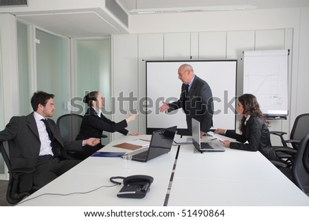 Two business people quarreling during a meeting with two other business people