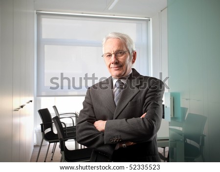 Meeting Room Manager on Senior Businessman Standing In A Meeting Room Stock Photo 52335523