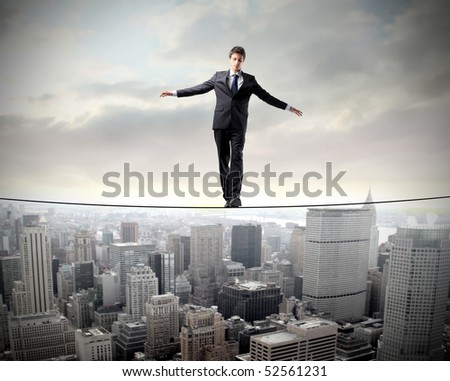 Stockphotos on Businessman In Equilibrium On A Rope Over A Cityscape Stock Photo