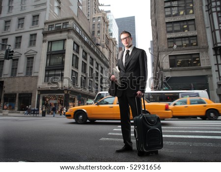stock photo : Businessman with suitcase standing on a city street