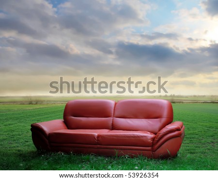 Sofa on a green meadow