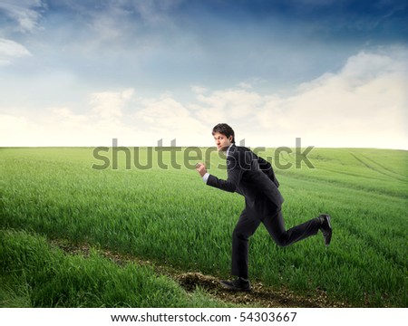 Businessman running on a countryside path