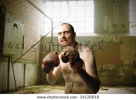 Boxer with aggressive expression in a gym