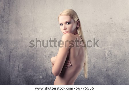 stock photo Beautiful naked woman covering her breasts with her hands