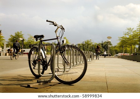 Bicycle secured on a parking in a city