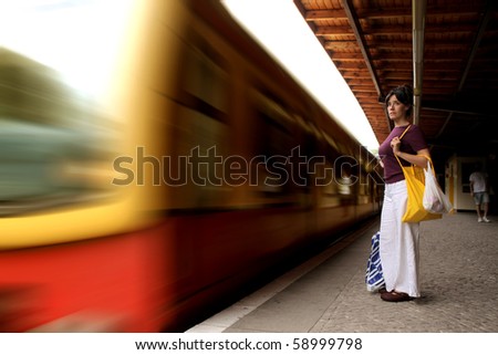 Woman standing on the platform of an underground train