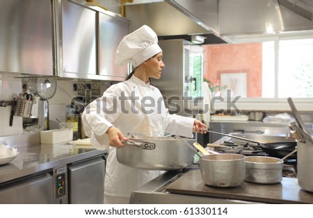 Female cook preparing food in a restaurant kitchen