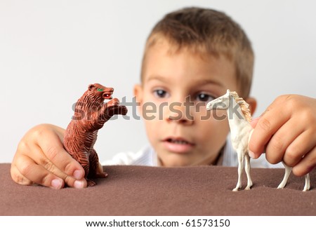 Child playing with two animal figures