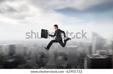 Businessman running fast over a city