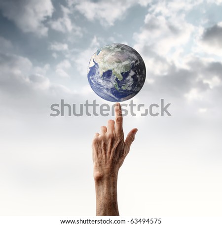 Senior\'s hand holding the earth on its finger