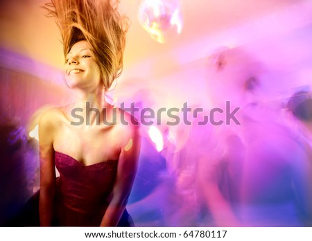 Smiling beautiful woman dancing in a disco