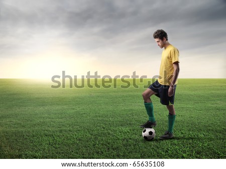 Soccer player on a green meadow Soccer player on a green meadow