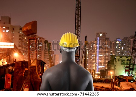 African man wearing a safety cap with construction site on the background