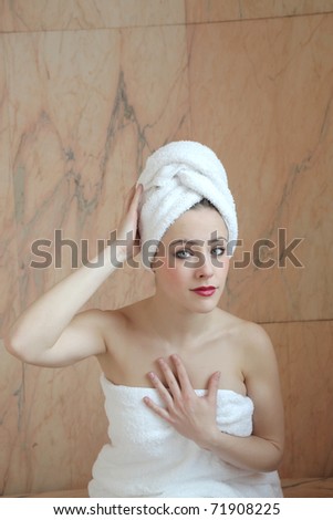 Beautiful woman wearing towels in a luxury bathroom