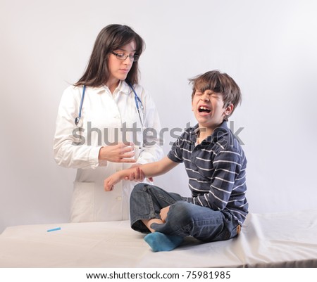 Female doctor vaccinating a crying child