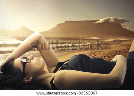 Beautiful woman tanning on a beach