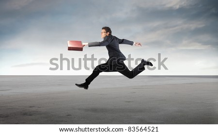 Businessman running in a desert