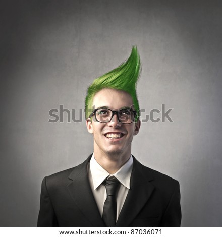 Smiling businessman with green upright hairstyle