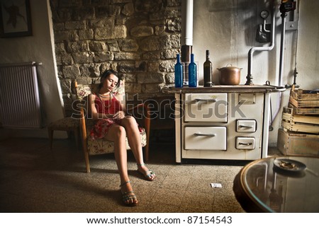 Young woman sleeping in an old kitchen