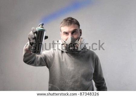 Young man spraying paint