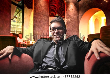 Smiling handsome man sitting in a lounge bar