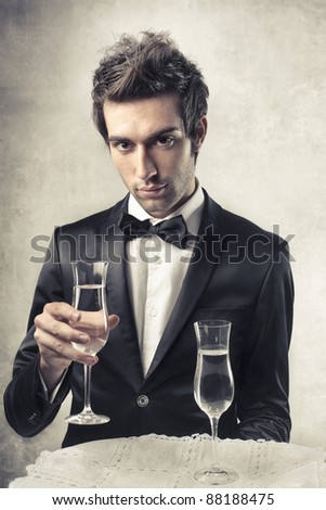 stock-photo-handsome-man-holding-a-glass-of-wine-88188475.jpg